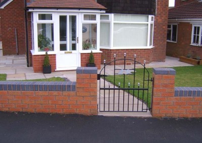 Completed boundary wall, path, gate and garden.